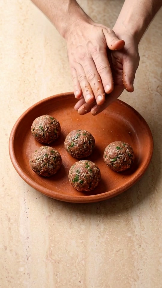 Step 2: Portion & Roll 16 Uniform Albóndigas: Lightly dampen your palms with cold water and roll the meat mixture into 16 smooth