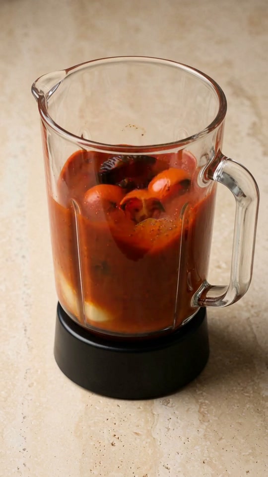 Step 4: Purée the Smoky Chipotle-Tomato Salsa: Peel the charred garlic and transfer it to a blender with the blistered Roma toma