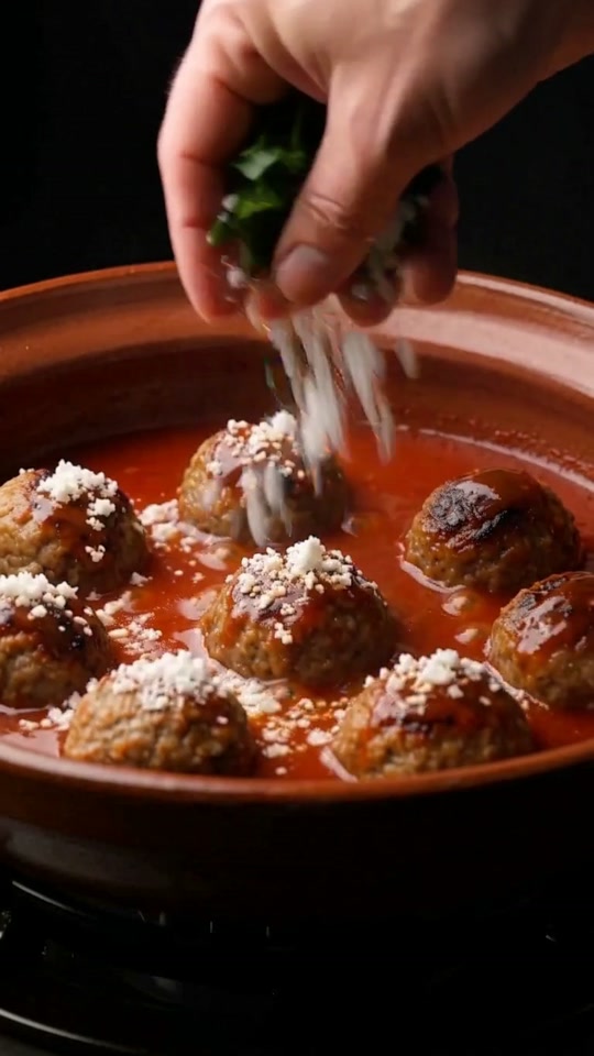 Step 6: Rest & Garnish with Aged Cotija and Cilantro: Remove the pot from the heat and let the albóndigas rest uncovered for 5 m