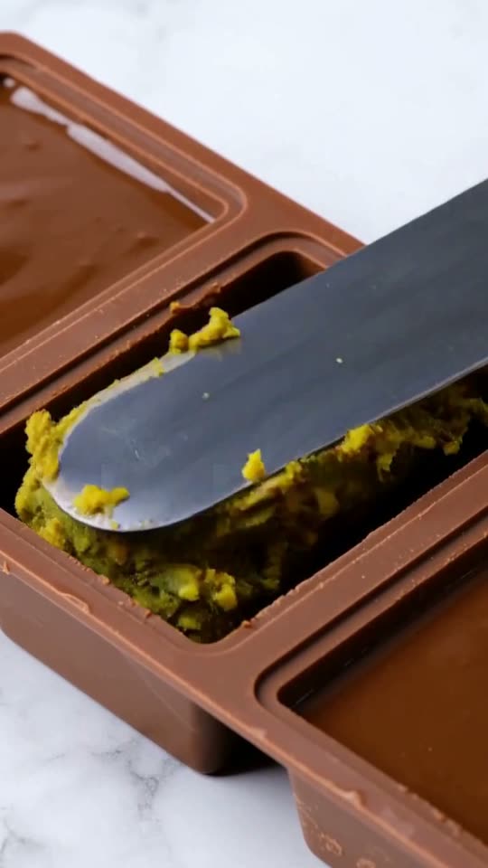 Step 5: Pack the Knafeh Core & Seal the Base: Spoon the pistachio-kataifi filling into the set chocolate shells, pressing gently