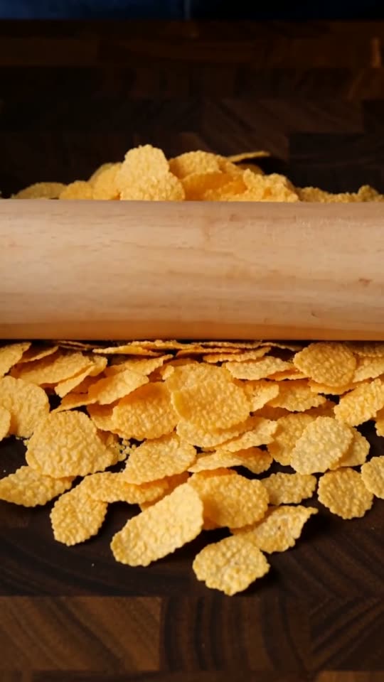 Step 2: Crush the Spiced Cornflake Coating: Place 180g plain cornflakes in a zip-top bag and roll with a rolling pin into coarse