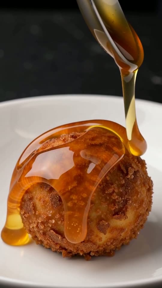 Step 6: Drain Briefly & Serve Immediately with Warm Honey: Lift the fried ice cream ball onto a paper towel for 3 seconds to blo