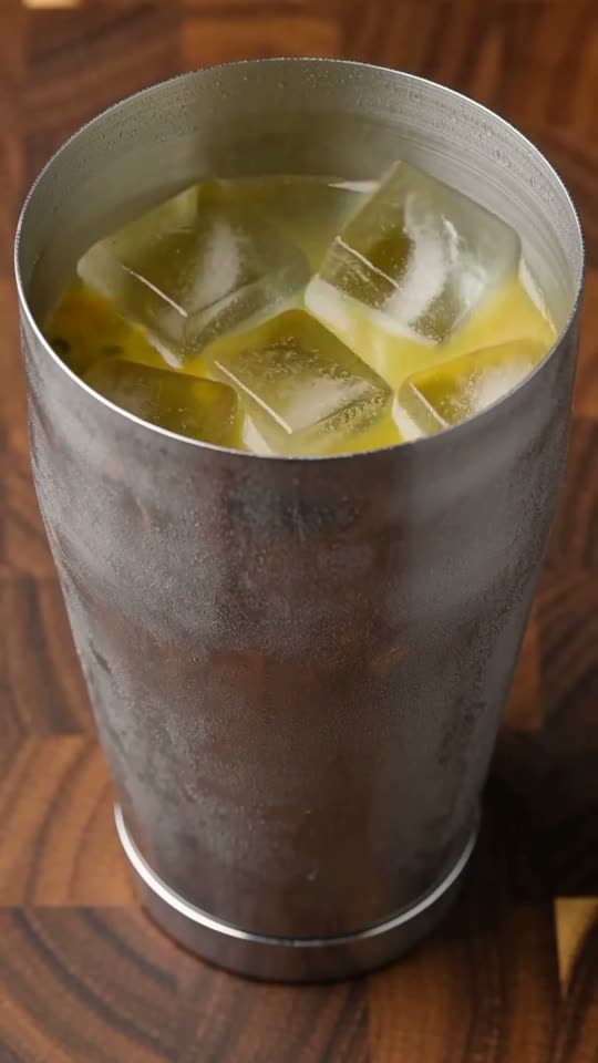 Step 4: Hard-Shake with Solid Ice Cubes: Fill the shaker two-thirds full with large, solid ice cubes from the freezer (avoid wet