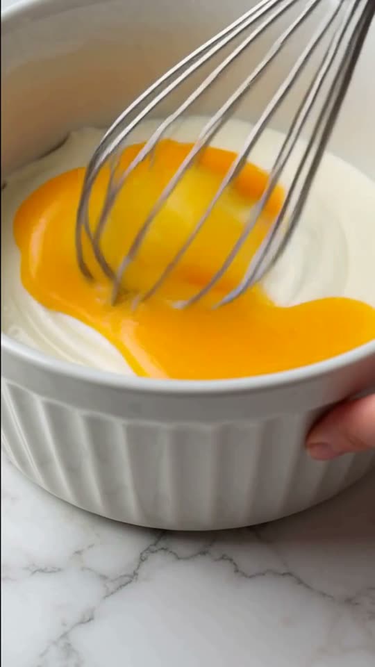 Step 3: Blend in Eggs One at a Time: Crack in the 4 room-temperature eggs one by one, mixing on low speed for 15 seconds after e