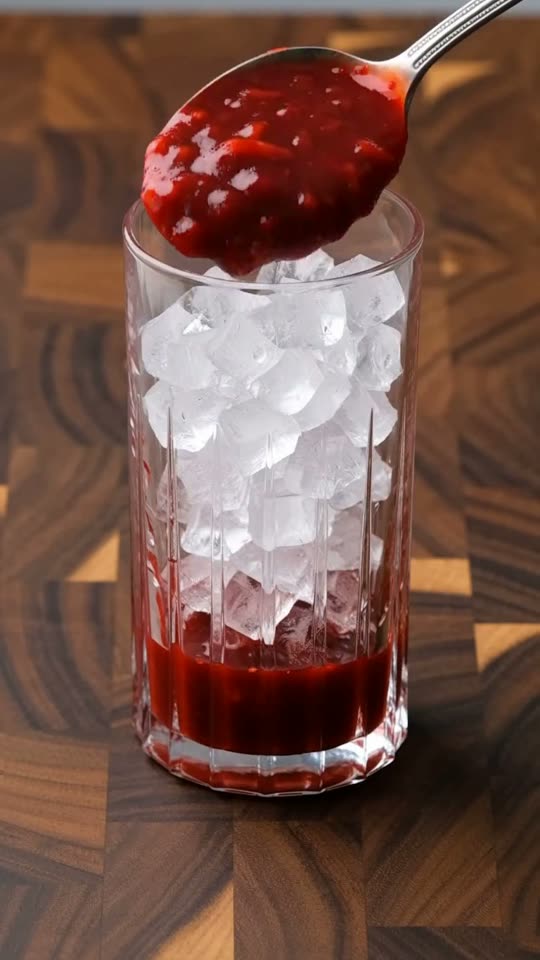 Step 5: Pack Chilled Glasses with Berry Compote & Ice: Spoon the syrupy strawberry compote evenly into the bottom of two chilled