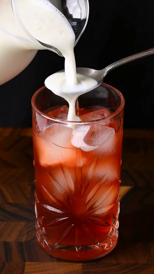 Step 6: Float the Cold Milk Over an Inverted Spoon: Hold the back of a bar spoon or teaspoon just above the ice and slowly pour
