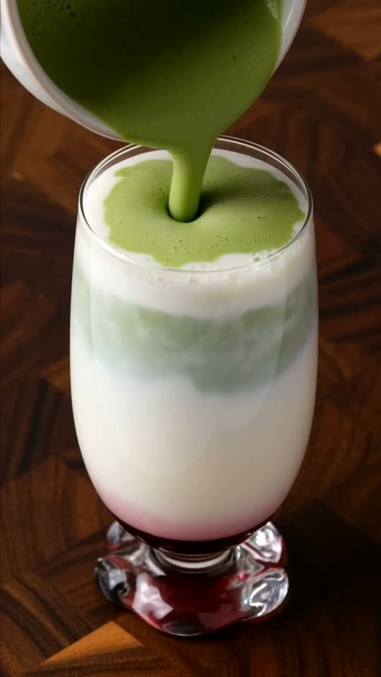Step 7: Crown with the Whisked Matcha Cloud: Slowly pour the warm, unsweetened whisked matcha over the back of the spoon onto th